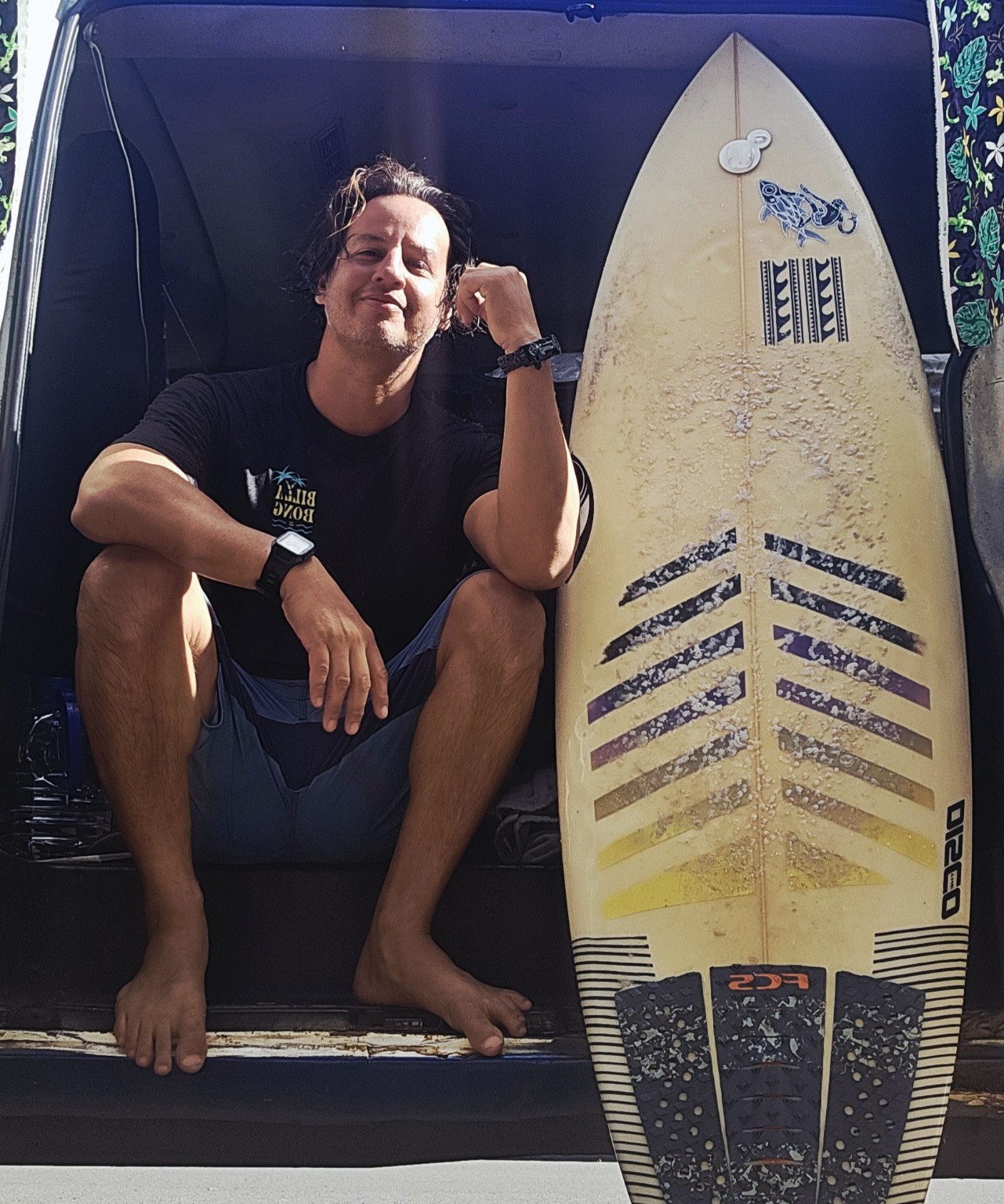 Daniel Luque beside his surfboard