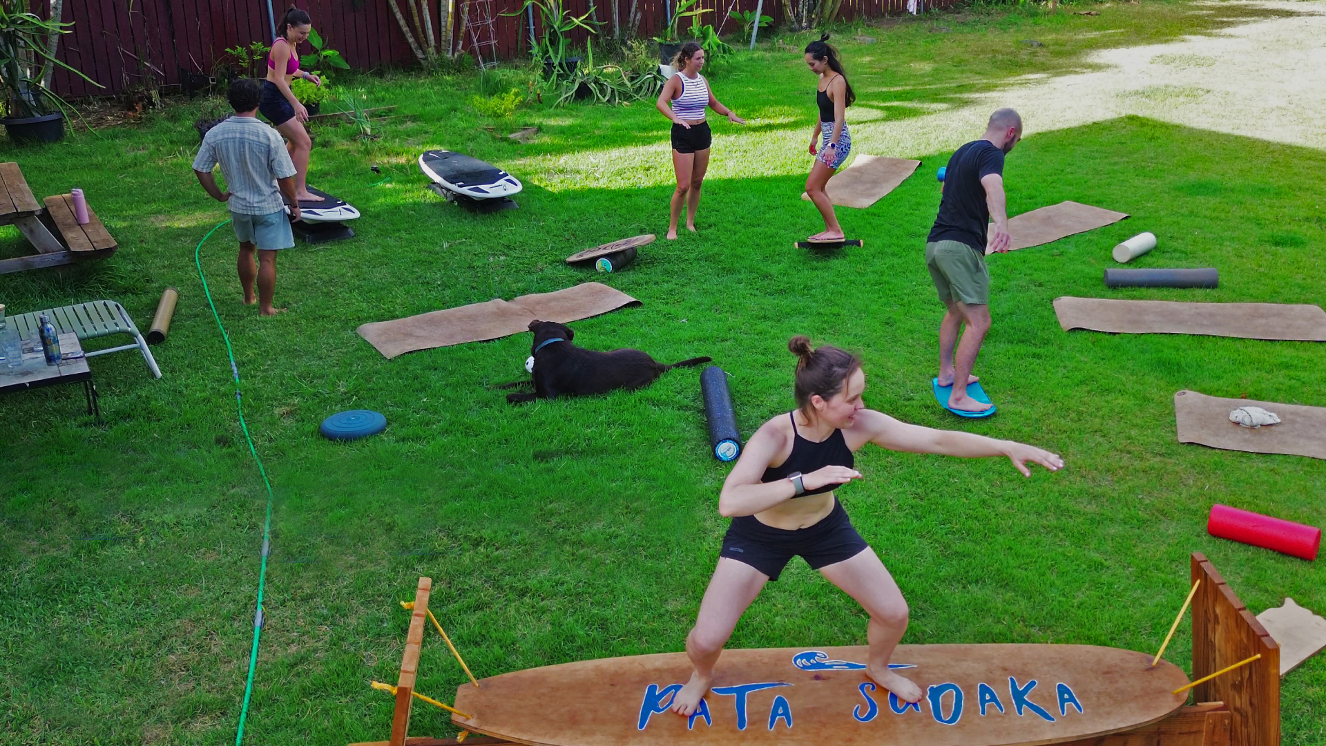Surfers practicing pop-up drills during surf ground training