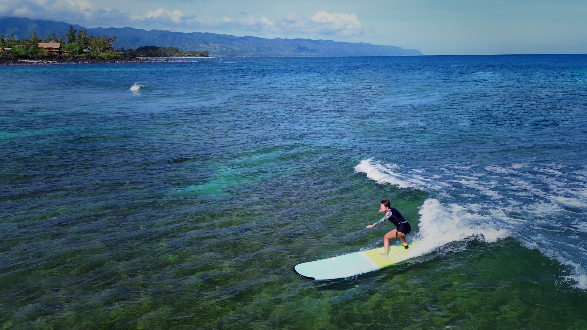 Surfer riding a blue Hawaiian wave