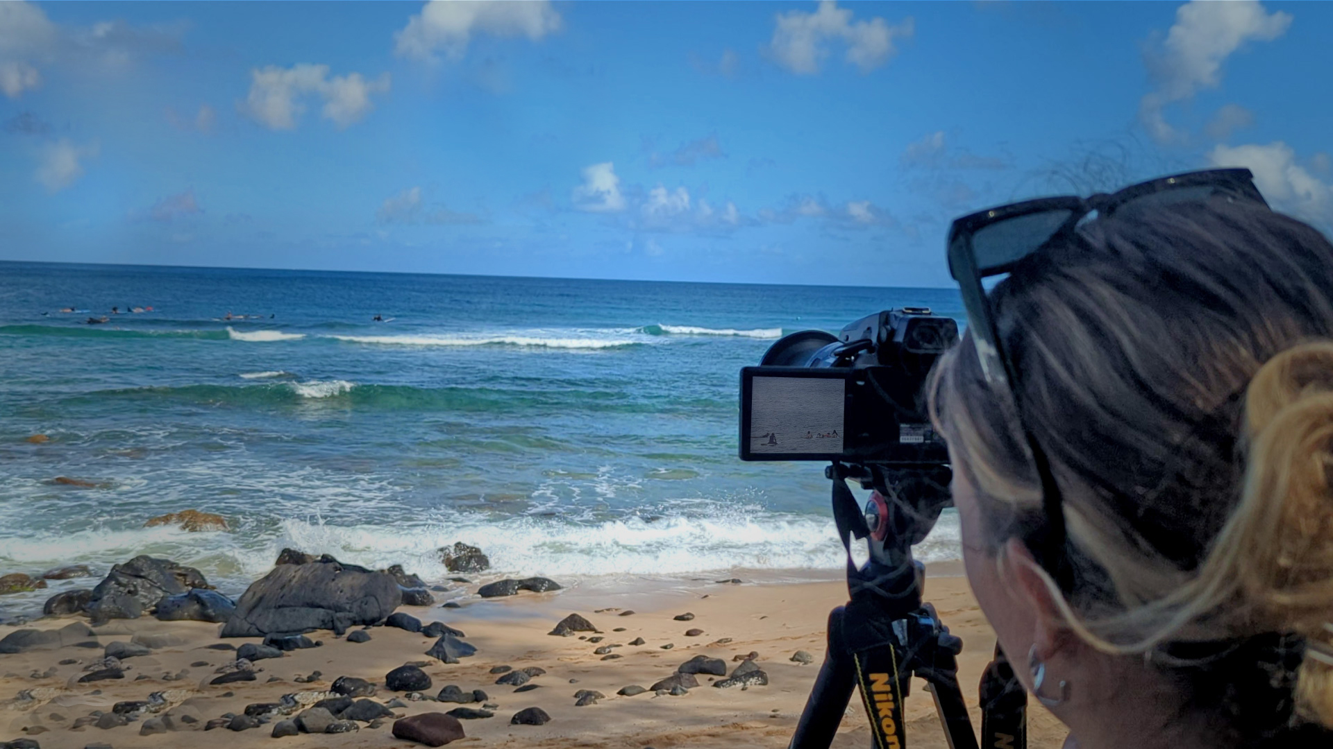 Coach filming a surfer for video analysis